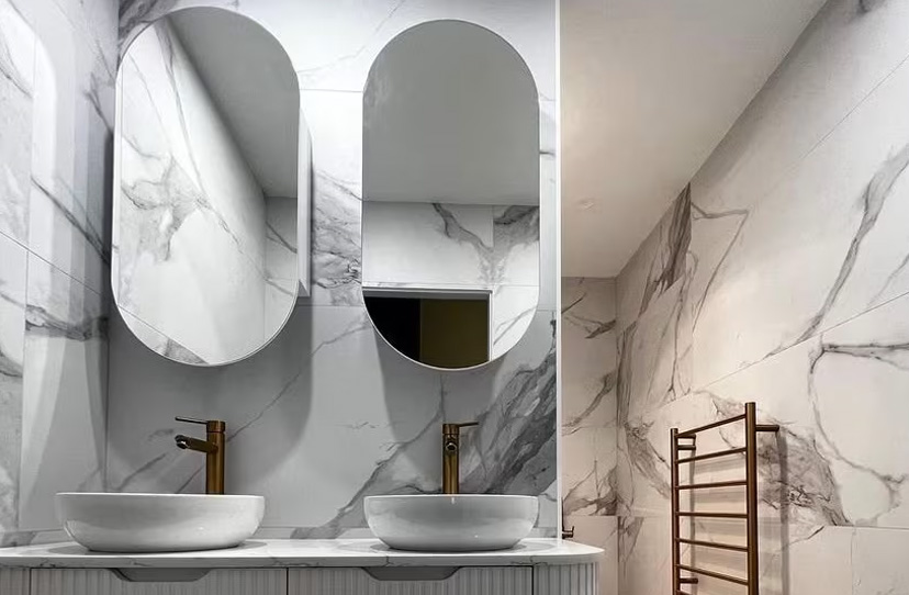 Modern custom built Sydney bathroom by Home Equity Constructions featuring marble finishes double mirrors and premium fixtures